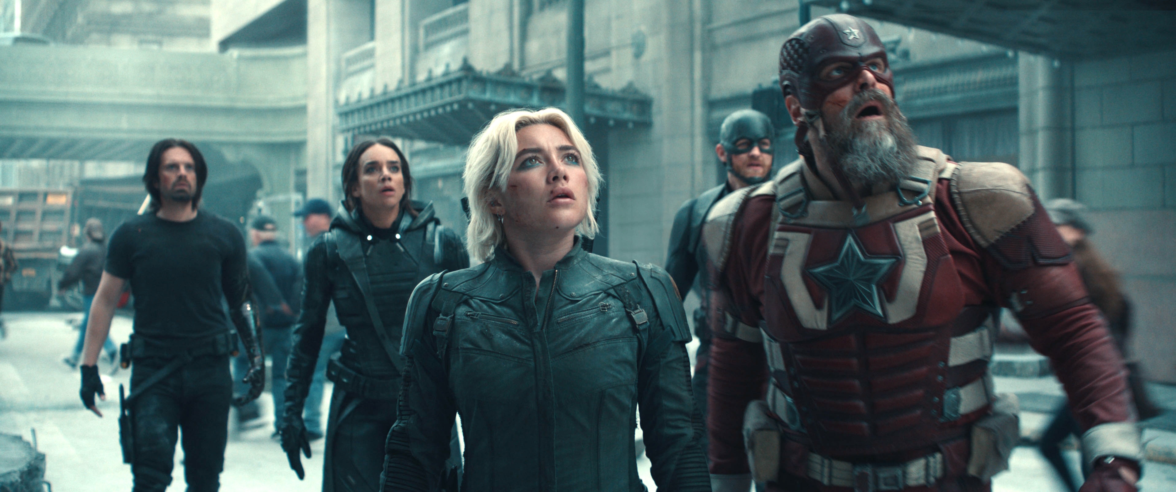 LtR: Bucky Barnes (Sebastian Stan), Ghost (Hannah John-Kamen), Yelena Belova (Florence Pugh), John Walker (Wyatt Russell), and Red Guardian/Alexei Shostakov (David Harbour) in Thunderbolts*. They’re all looking up at something looking surprised.