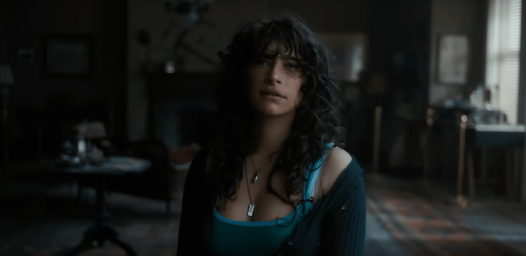 Odessa A’zion in the Until Dawn movie, standing in a huge house looking toward the camera
