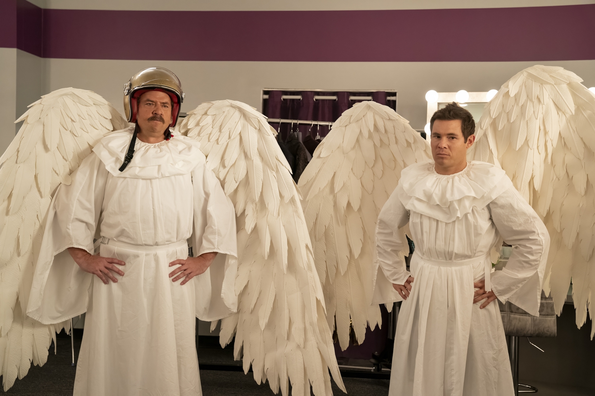 Danny McBride and Adam Devine wearing ridiculous angel wings and costumes (while McBride wears a helmet) in The Righteous Gemstones