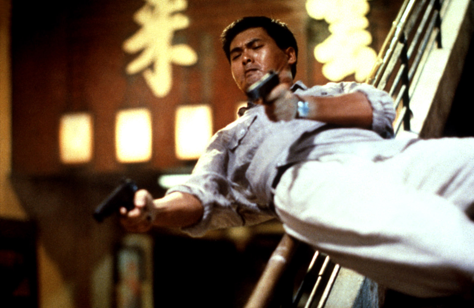 Chow Yun-fat diving while firing two pistols in Hard Boiled