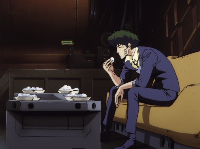 Spike, slumped alone over a table, eating food in Cowboy Bebop