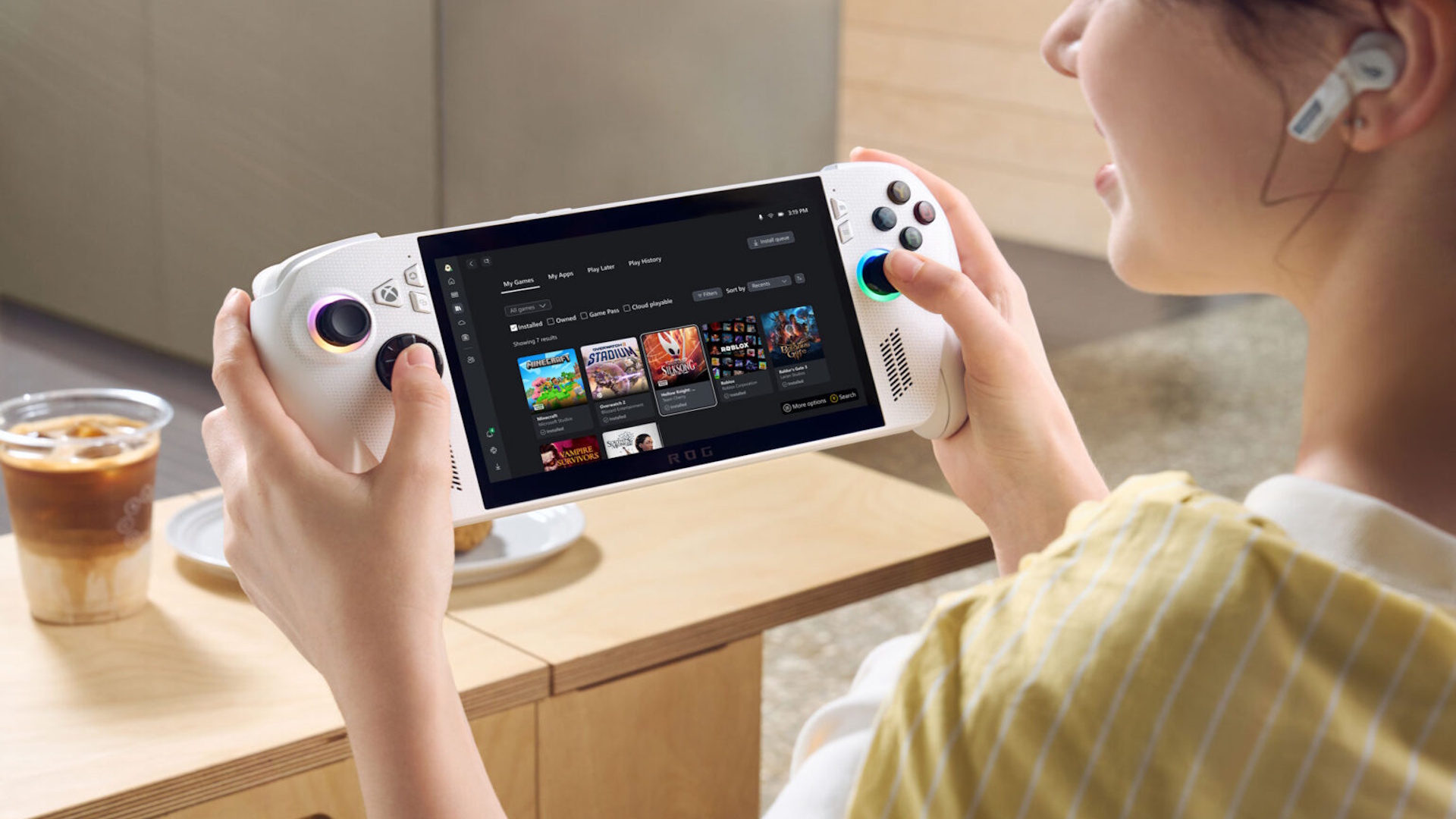 A person playing the smaller Rog Xbox Ally, which is white, and not as heavy as the other one