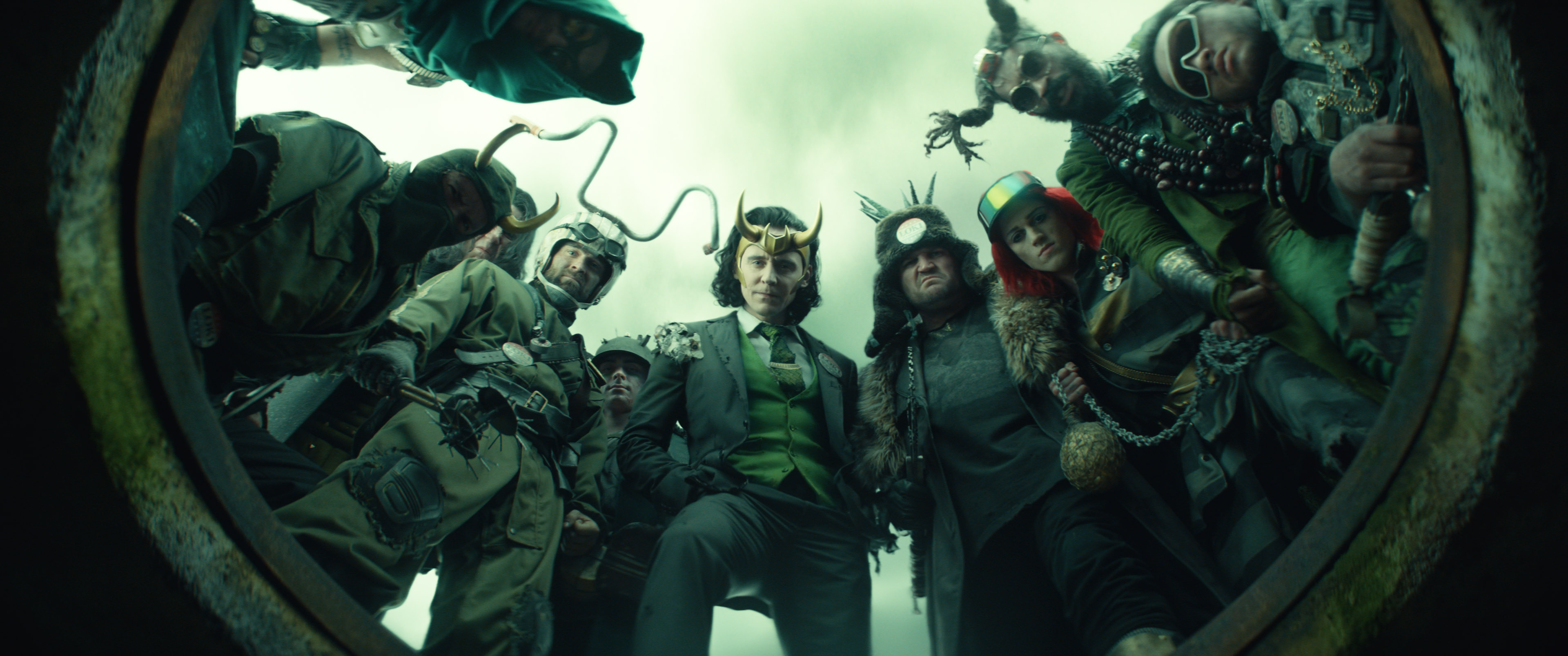 A whole buncha Lokis, centered on President Loki, look down at the camera in episode 5 of Loki