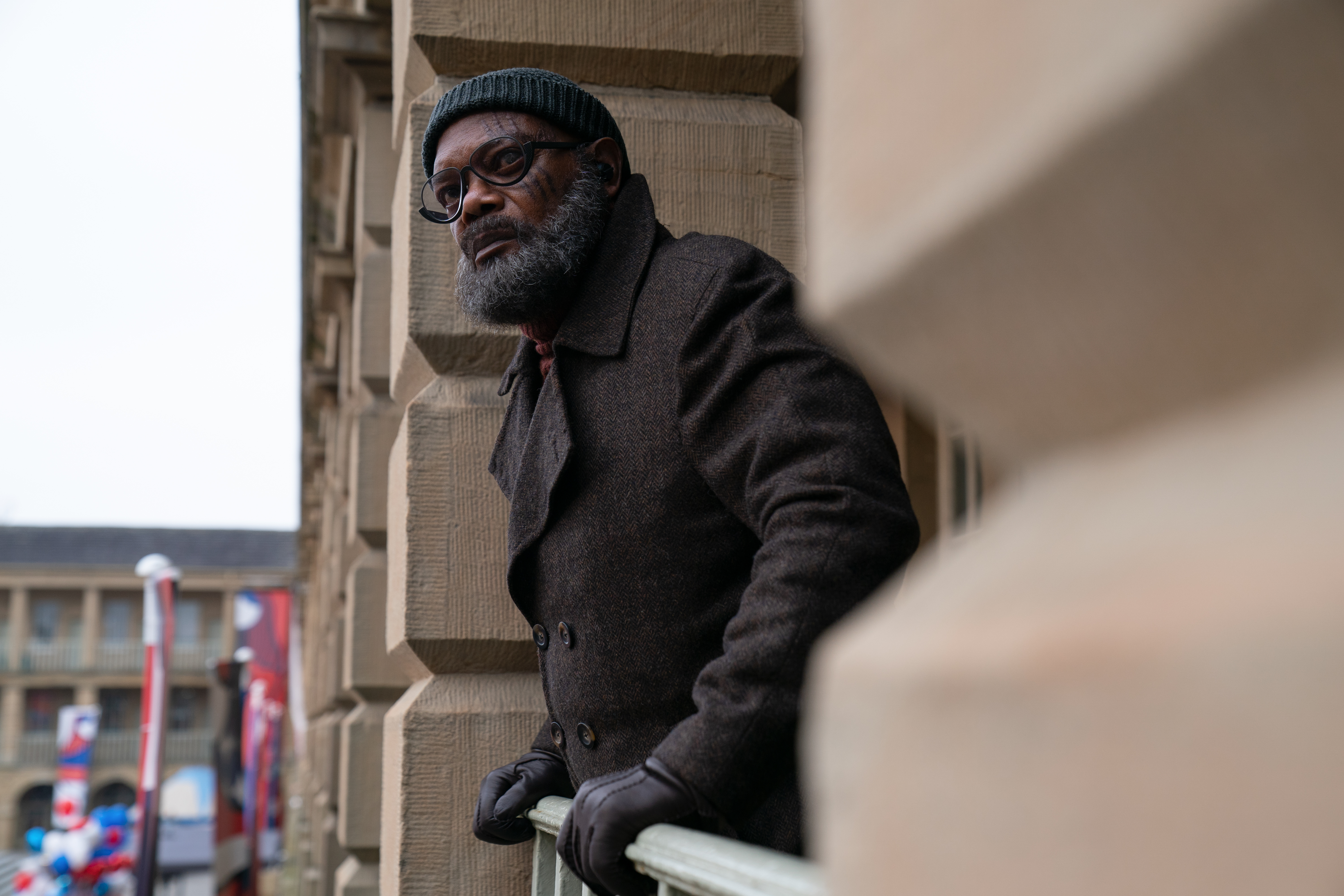 Nick Fury (Samuel L. Jackson) leans over a railing looking at something
