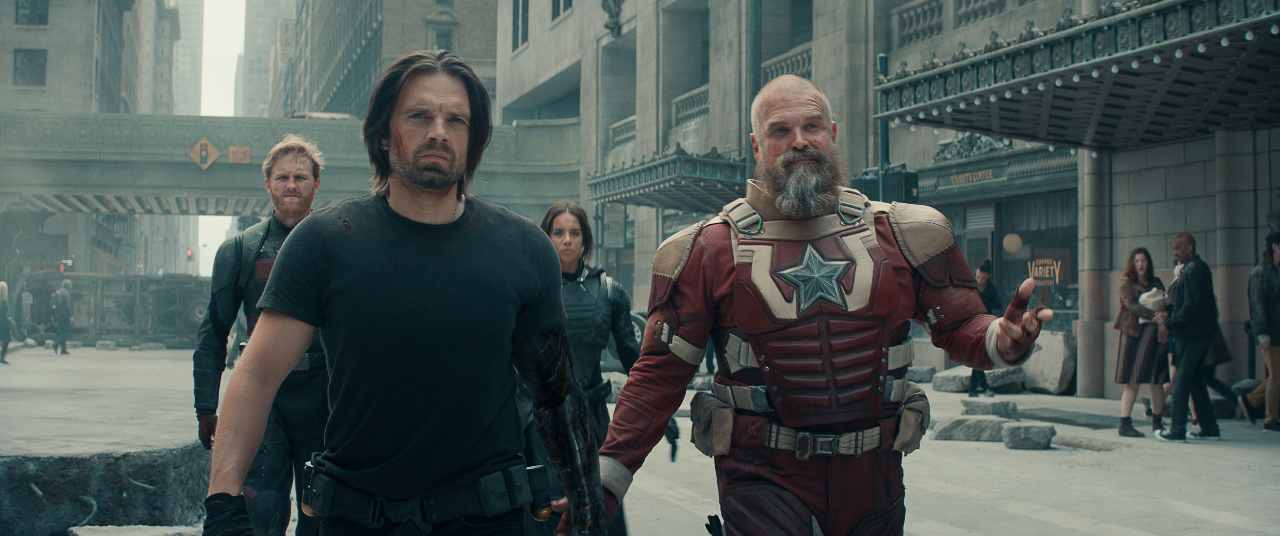 Bucky (Sebastian Stan), Red Guardian (David Harbour) and the other members of the Thunderbolts walk toward the camera on a rubble-strewn Manhattan street in Thunderbolts*