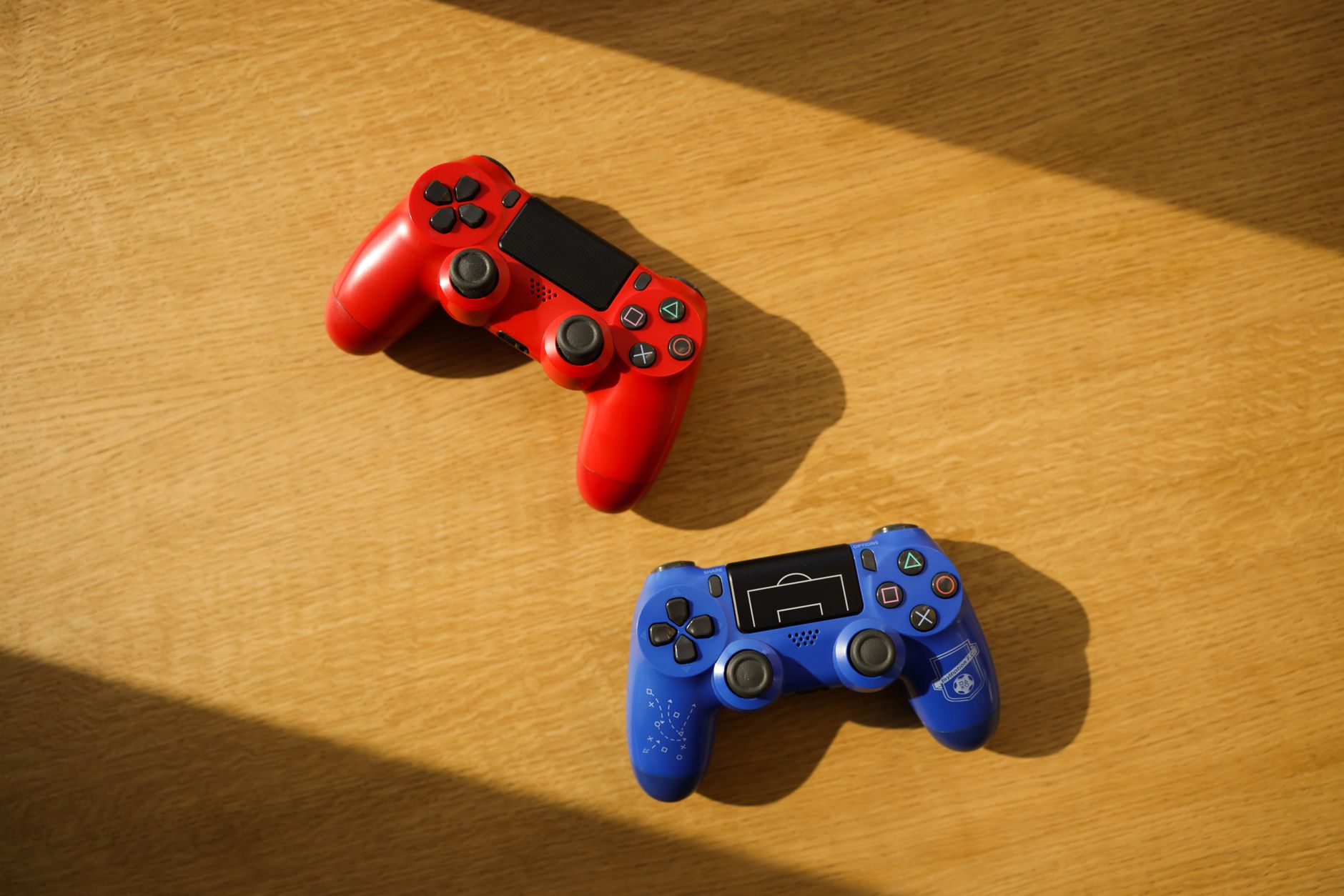 A close-up of a gaming controller on a dark surface