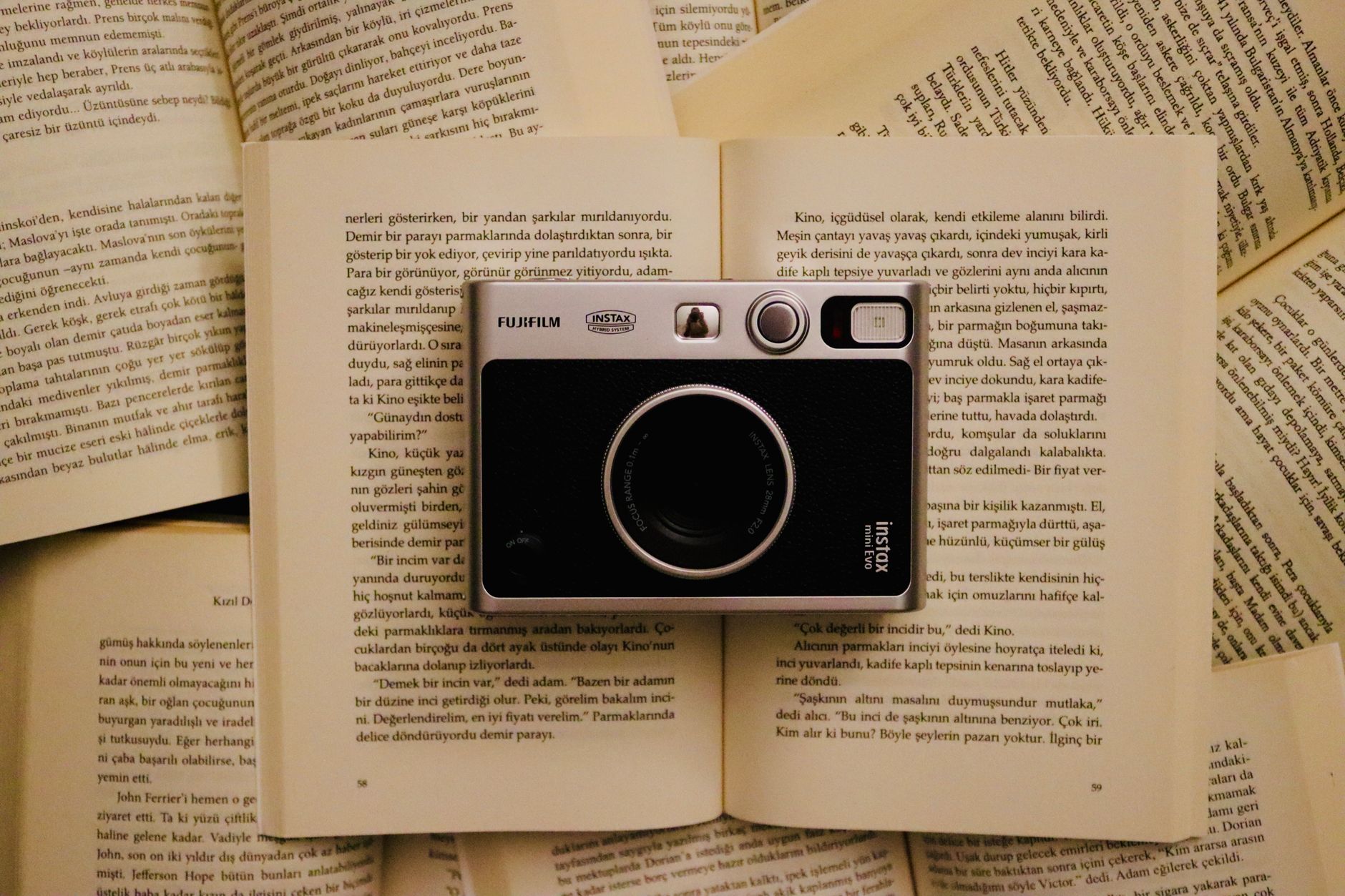 A book open next to a film reel representing book to screen adaptations