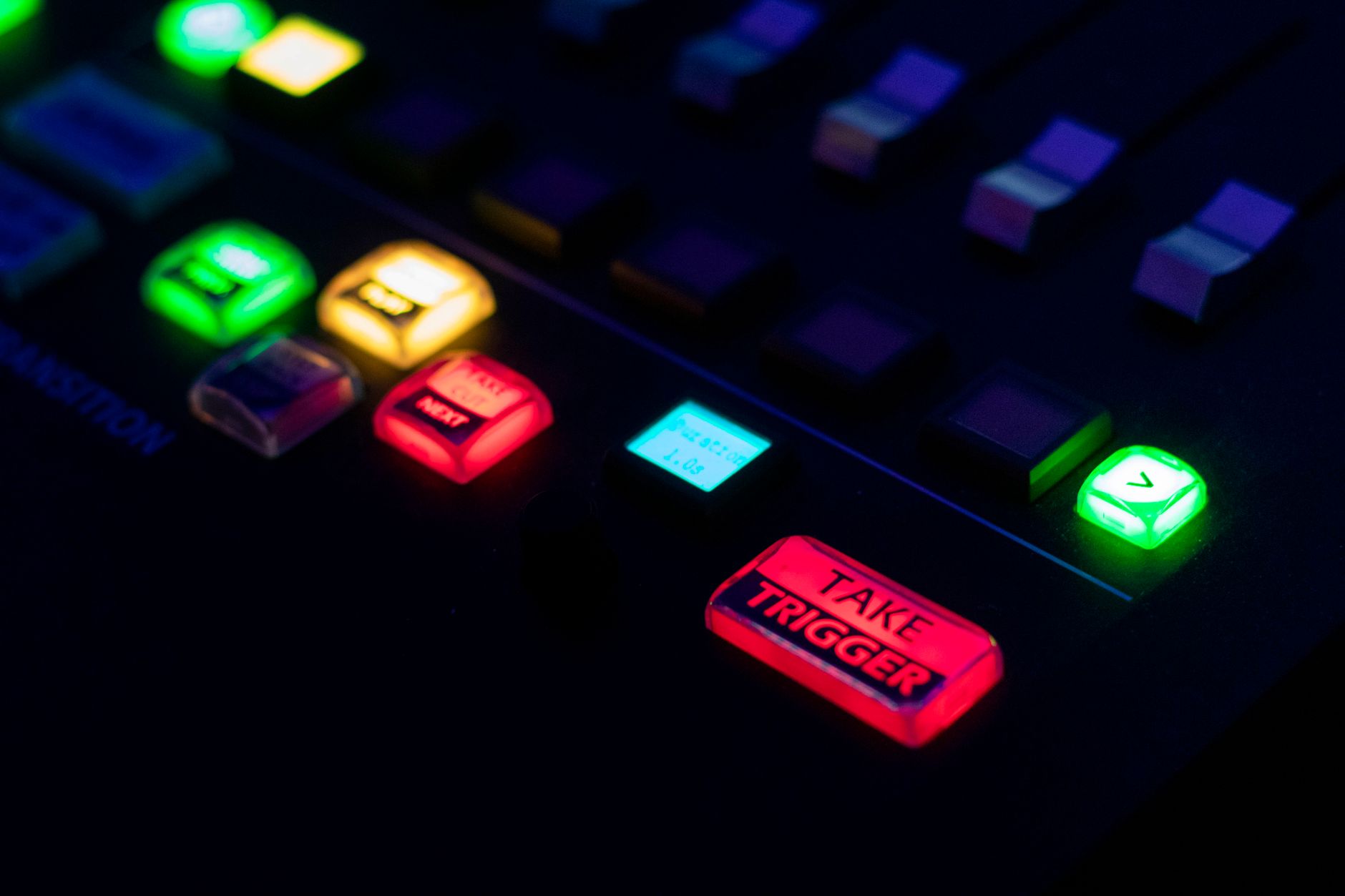 A glowing neon console or arcade machine in a dark environment