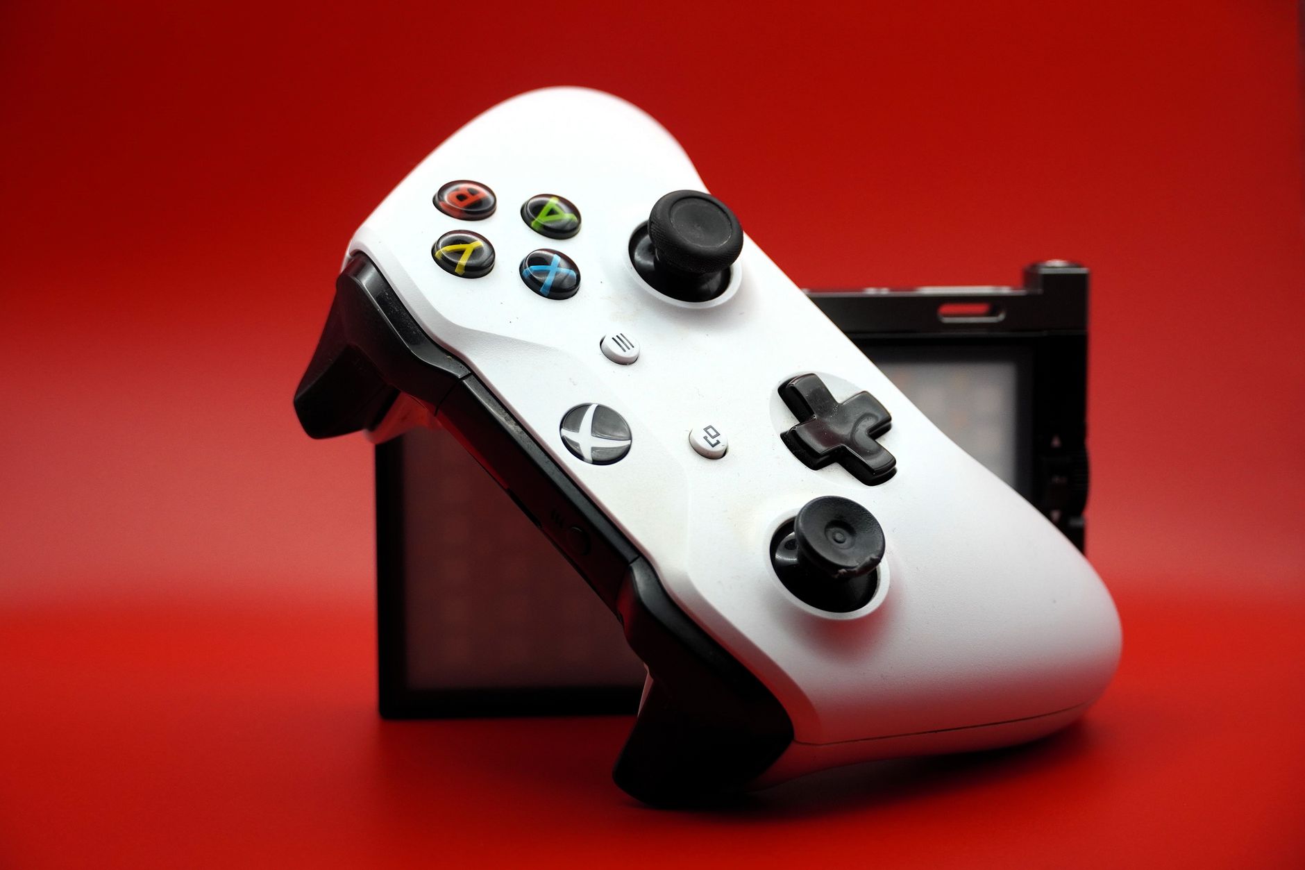 An Xbox controller resting on a gaming desk