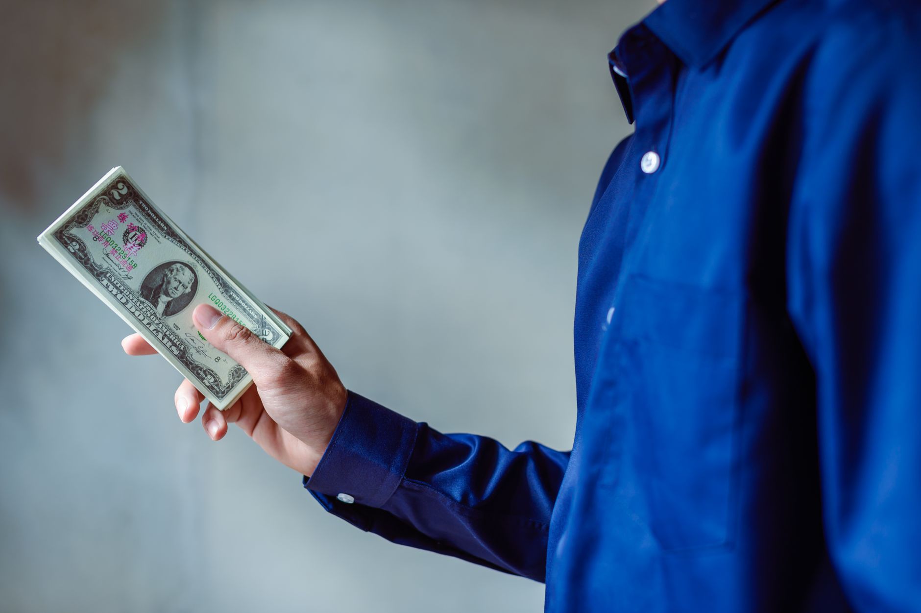 Hands counting coins representing consumer savings