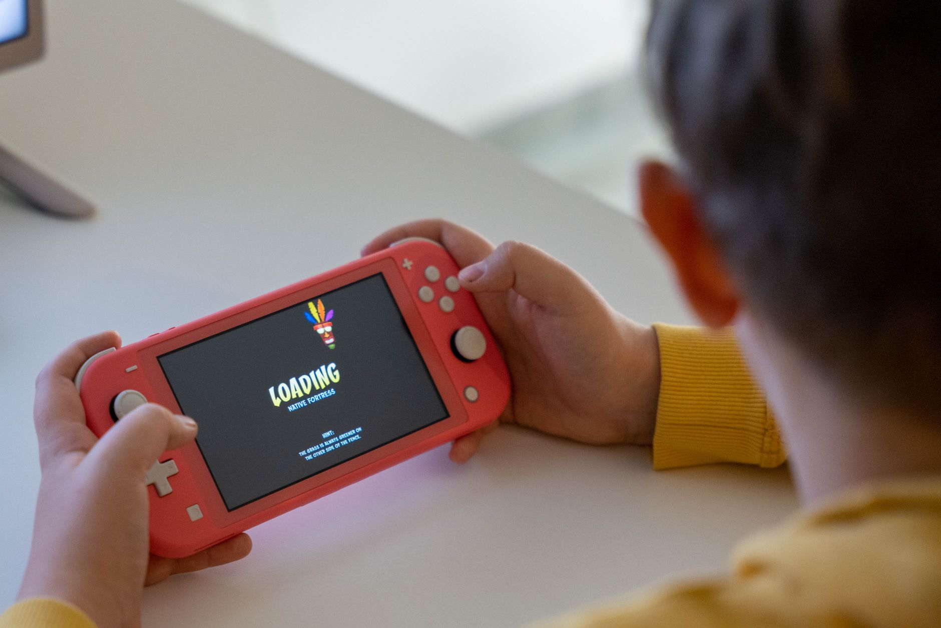 Person playing a handheld gaming device